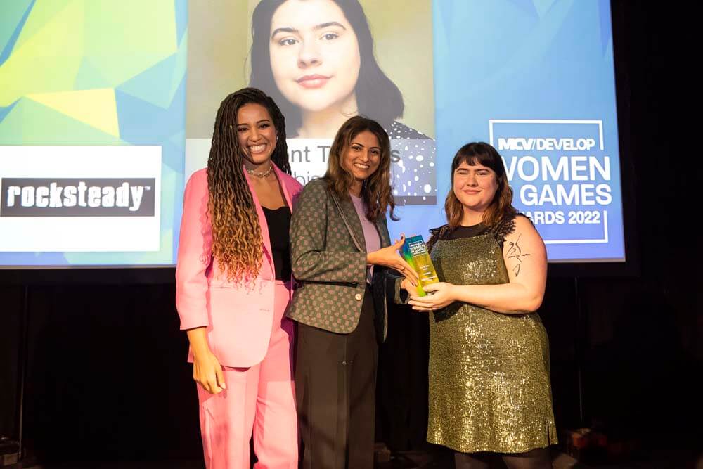 Photo of&nbsp;Rocksteady’s Lead UI Artist, Helen Kaur, presenting the Rising Star Award to this year's winner&nbsp;Millicent Thomas alongside MCV Women In Games Awards 2022 Host Elle Osili-Wood.